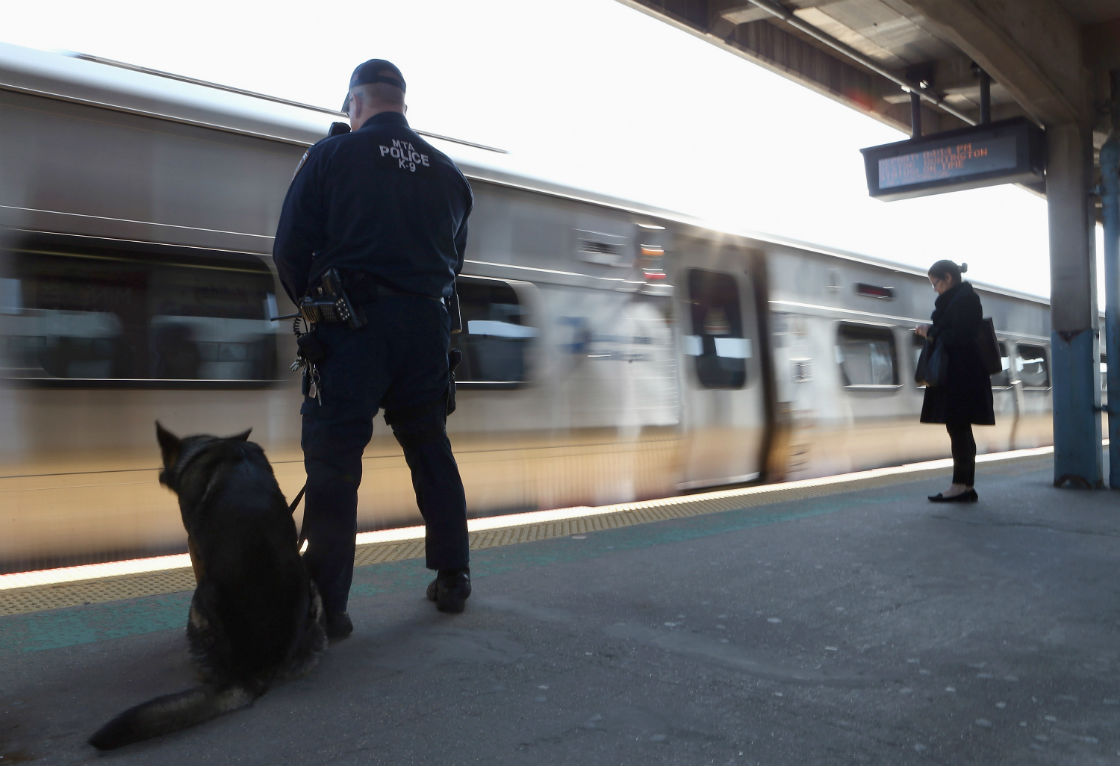 A police officer with his K-9 companion keeps guard as a Long Island Rail Road train from New York City arrives at the station on April 15, 2013 in Hicksville, New York. 