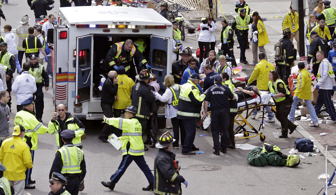 Medical workers aid injured people at the finish line of the 2013 Boston Marathon  in Boston, Monday, April 15, 2013.   