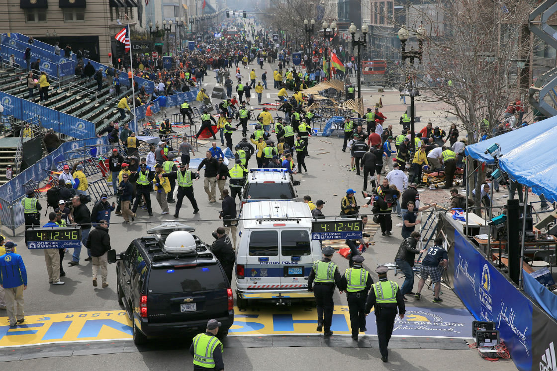 Emergency personnel respond to the scene after two explosions went off near the finish line of the 117th Boston Marathon on April 15, 2013. (Photo by David L. Ryan/The Boston Globe via Getty Images).