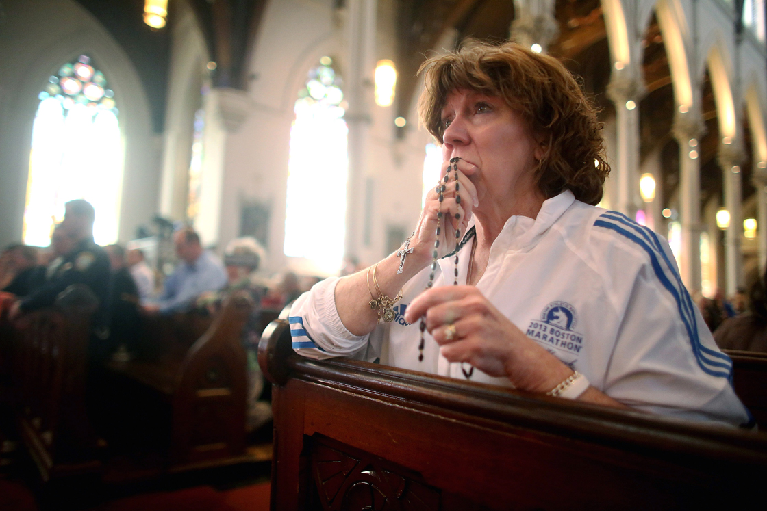 Nurse practitioner Maureen Quaranto (R), who treated victims of the Boston Marathon bombings in Tent A, wears her Boston Marathon jacket during Mass at the Cathedral of the Holy Cross on the first Sunday after the Boston Marathon bombings on April 21, 2013 in Boston, Massachusetts.