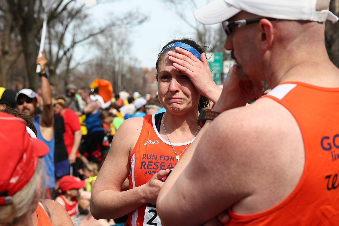 A runner reacts after bombs exploded at the 2013 Boston Marathon