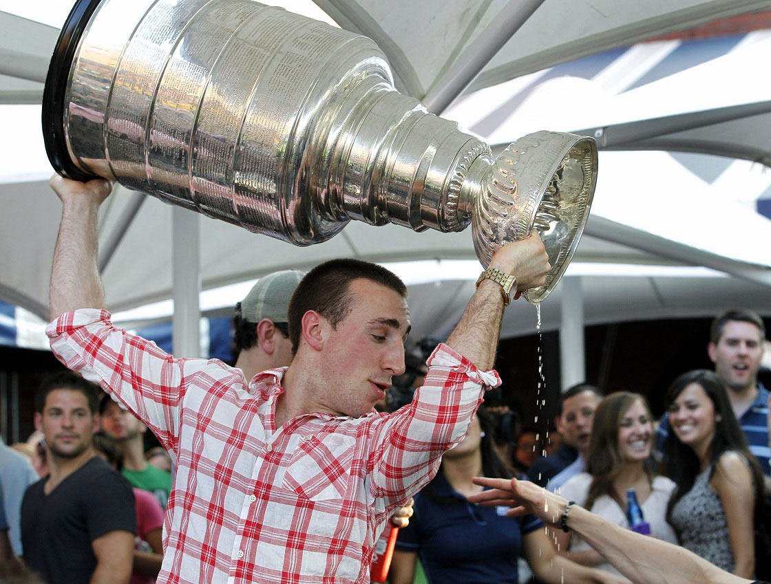 The president of NB Liquor says the return of NHL games after the lockout was a boon for liquor sales in New Brunswick. In this file photo Boston Bruins' Brad Marchand watches beer dribble from the Stanley Cup at Tia's Restaurant in Boston on Thursday, June 16, 2011. 