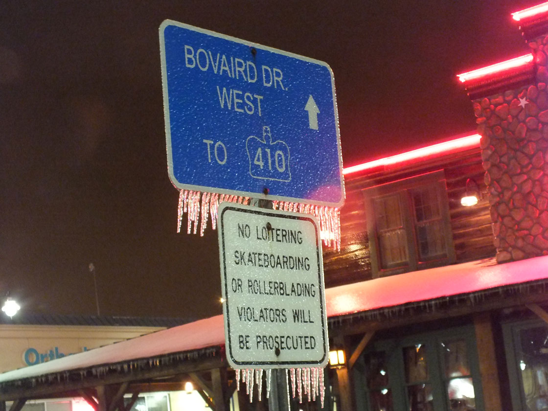 Ice covers a road sign in Brampton, Ontario on April 12, 2013. Environment Canada issued an ice storm warning Friday morning for a large portion of the Greater Toronto Area.  