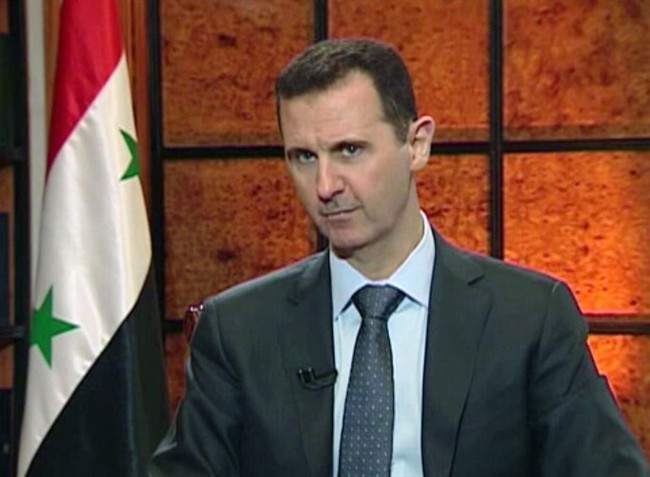 In this image from video broadcast on Syrian state television Wednesday, April 17, 2013, President Bashar Assad speaks during an interview. 