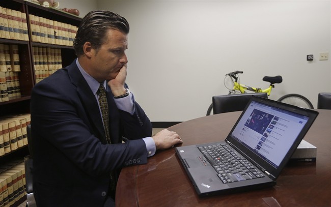 Robert Allard, an attorney for the family of Audrie Pott, watches a video of Pott at his office in San Jose, Calif., Friday, April 12, 2013. 