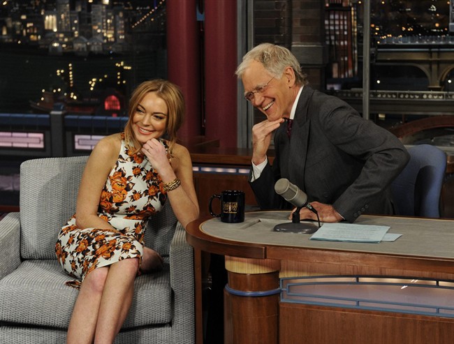 In this Tuesday, April 9, 2013 photo released by CBS Entertainment, actress Lindsay Lohan talks to David Letterman about her upcoming trip to rehab.