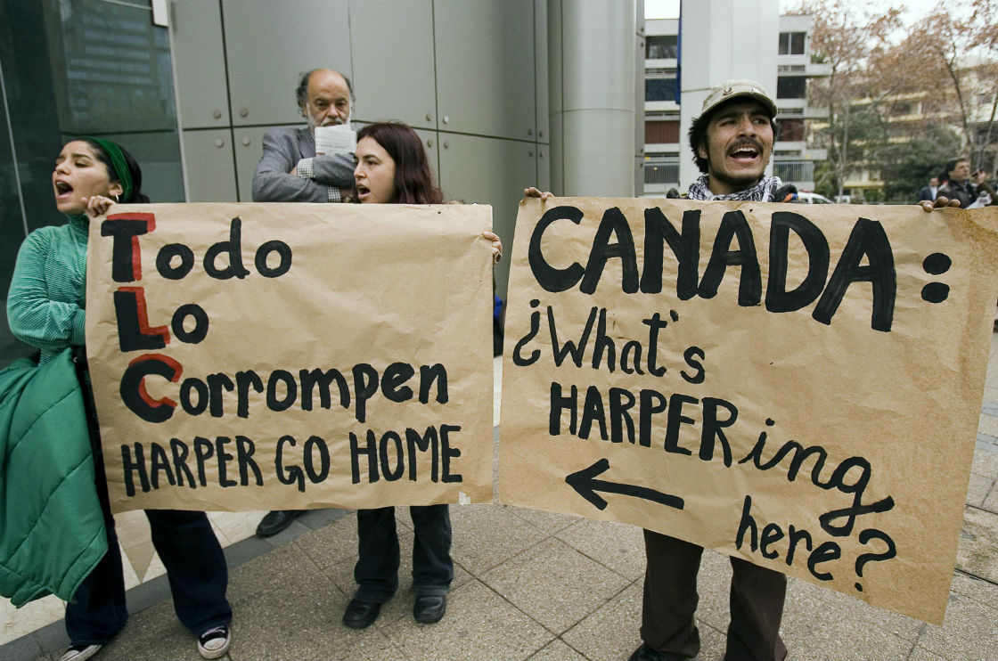 A small group of protesters demonstrate outside the offices of Barrick Gold during a visit by Prime Minister Stephen Harper in Santiago, Colombia Wednesday, July 18, 2007. The protests was against the mining company's open pit mining project in Pascua Lama, Chile. (File photo).