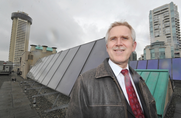 Jim Mockford, general manager at The Listel Hotel, stands next to solar panels on the roof of the Vancouver hotel on April 18, 2013. The solar panels are part of an energy-efficient hot water system that saves the hotel $55,000 a year on natural gas expenses.
