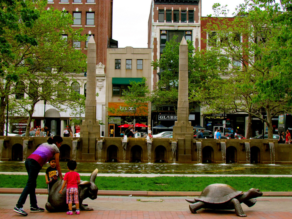 A family gathers by the fountain in Copley Square.