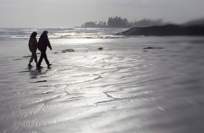A couple are silhouetted with a tilt shift camera lens as they walk along the Beach in Pacific Rim National Park near Tofino, B.C.