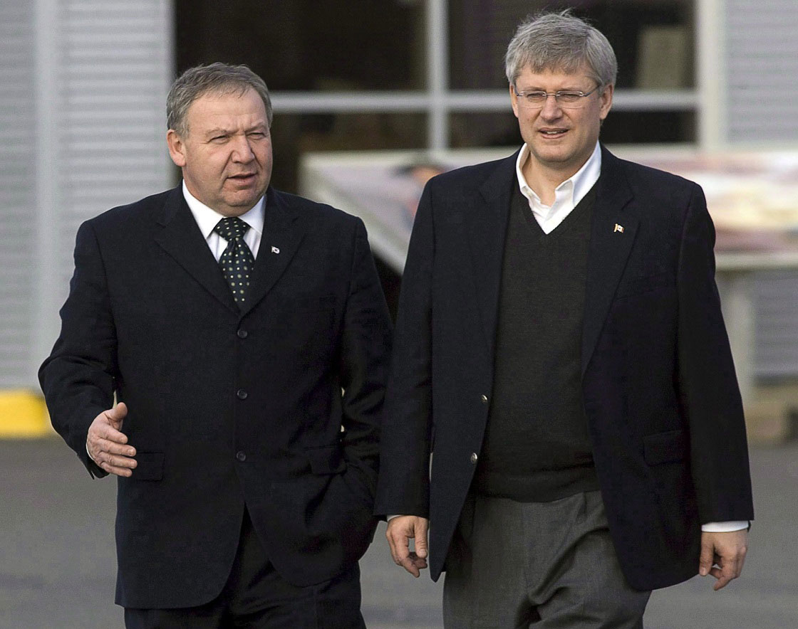 Prime Minister Stephen Harper walks with Nova Scotia Premier Darrell Dexter, left, on the dock at the marine terminal in Sydney, N.S. on Friday, Dec. 10, 2010. Dexter says he'll talk to Stephen Harper this week about changing the criminal code in response to the death of 17-year-old Rehtaeh Parsons.