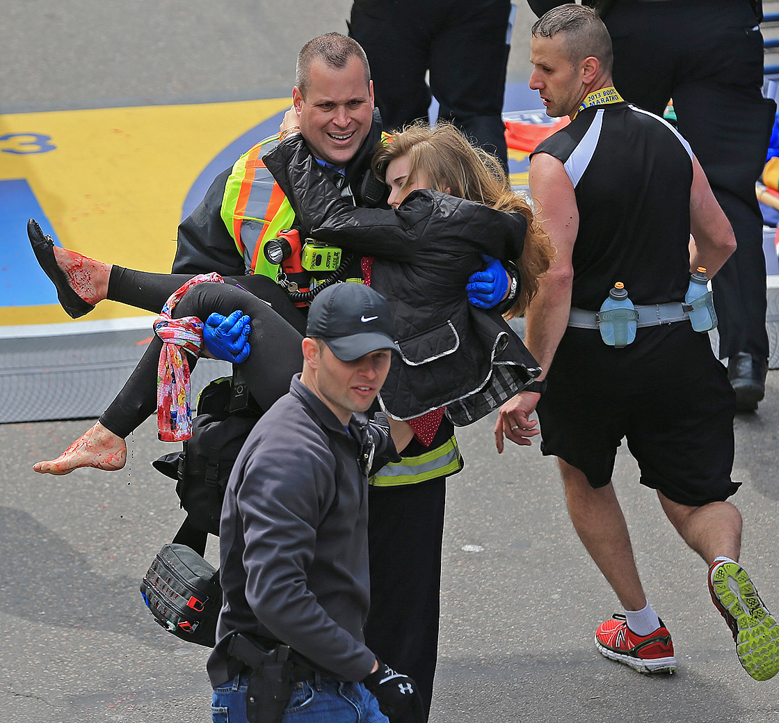 Emergency personnel respond to the scene after two explosions went off near the finish line of the 117th Boston Marathon on April 15, 2013.