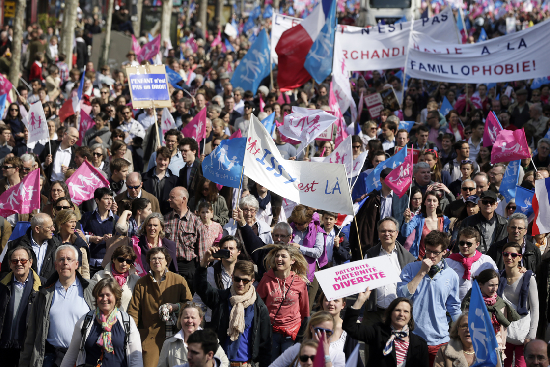 Anti-gay marriage activists hold flags and banners as they take part in a demonstration of the anti-gay marriage movement "La Manif Pour Tous" (Demonstration for all!) on April 21, 2013 in Paris. 