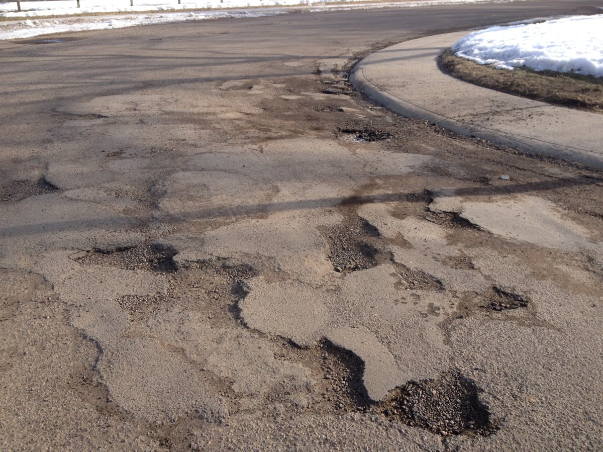 Potholes cover a road in south Edmonton, April 2013.