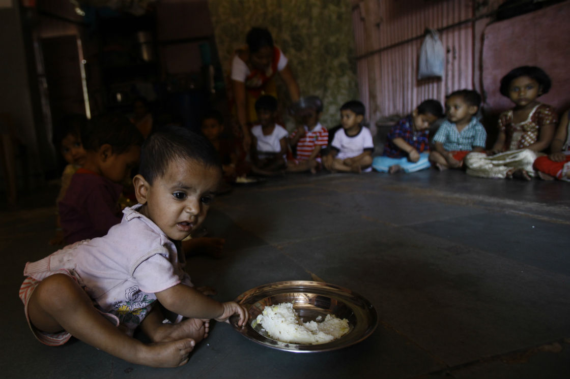 A young child eats at a malnutrition rehabilitation center run by a non-governmental organization Apnalaya in Mumbai, India, Monday, April 15, 2013. A United Nations Children’s Fund report has found that more than a quarter of children under age 5 worldwide are permanently "stunted" from malnutrition, leaving them physically and intellectually weak and prone to early death. 