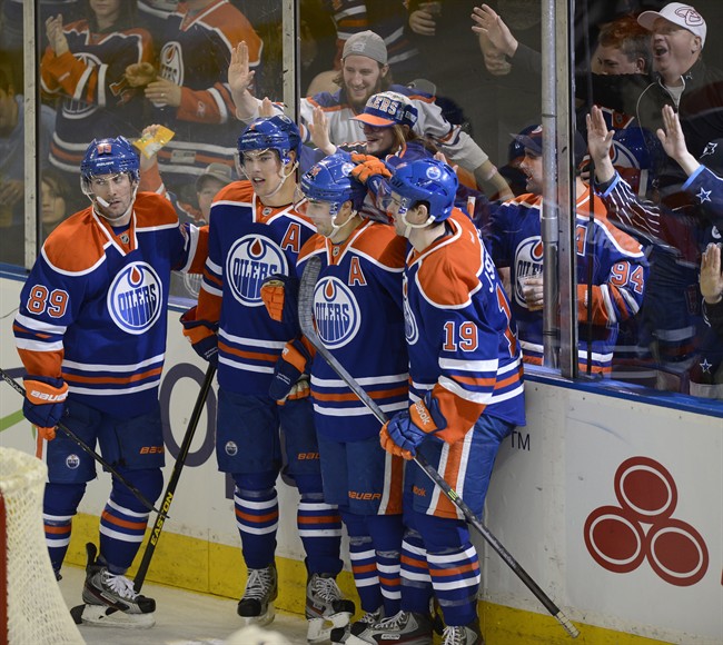 Edmonton Oilers' Sam Gagner, Taylor Hall, Jordan Eberle and Justin Schultz celebrate a goal by Eberle against the Vancouver Canucks during second period NHL hockey action in Edmonton, on Saturday, April 27, 2013. 