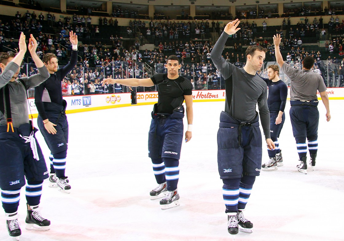 Members of the Winnipeg Jets salute the home fans for the final time at centre ice after a 4-2 loss to the Montreal Canadiens in their regular season finale at the MTS Centre on April 25.