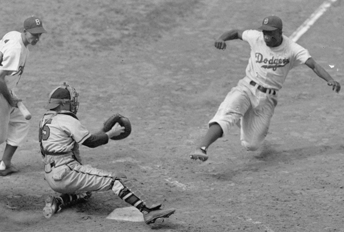 Brooklyn Dodgers Jackie Robinson stealing home plate