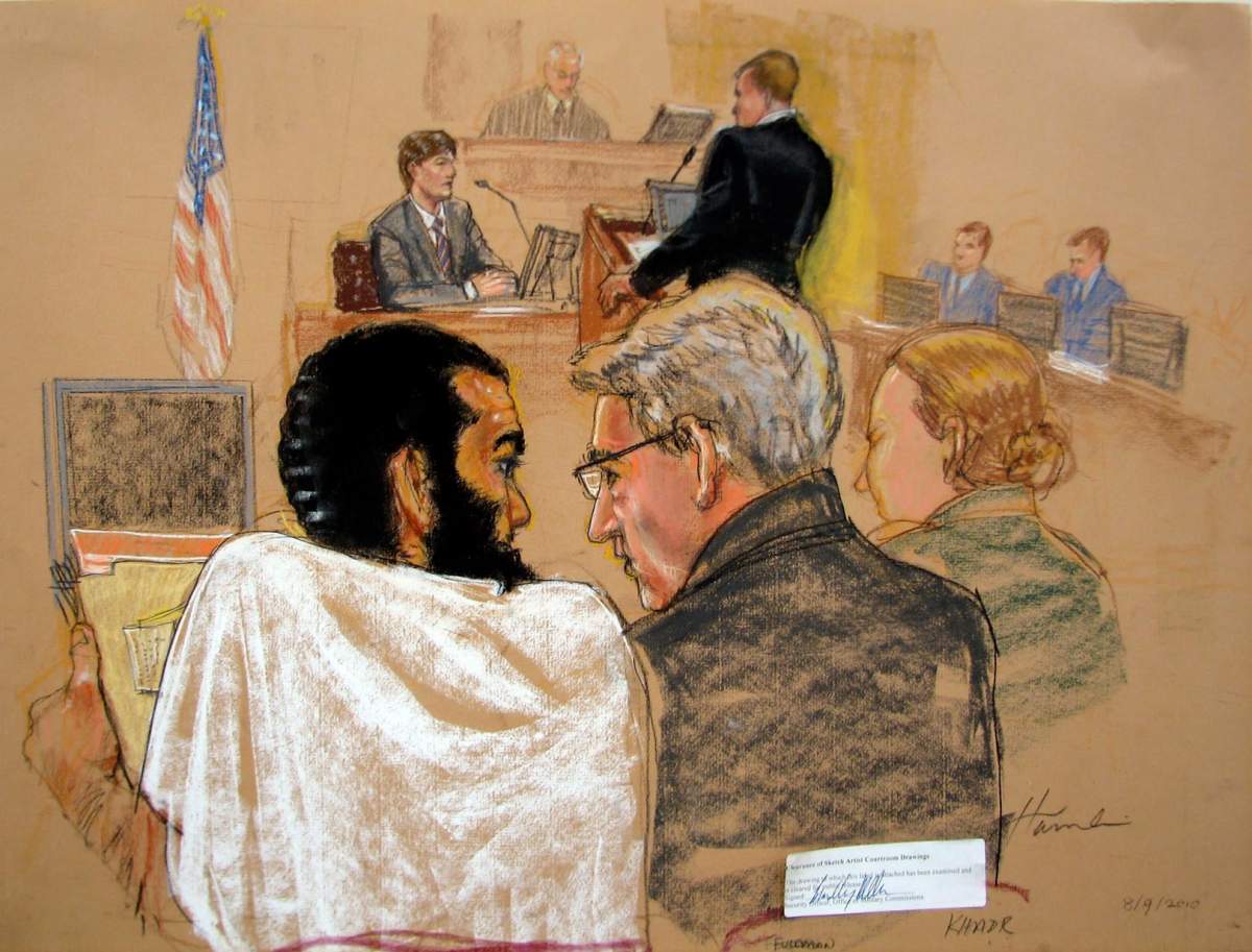 Omar Khadr sits beside lawyer Dennis Edney at a Guantanamo Bay courtroom in August, 2010.