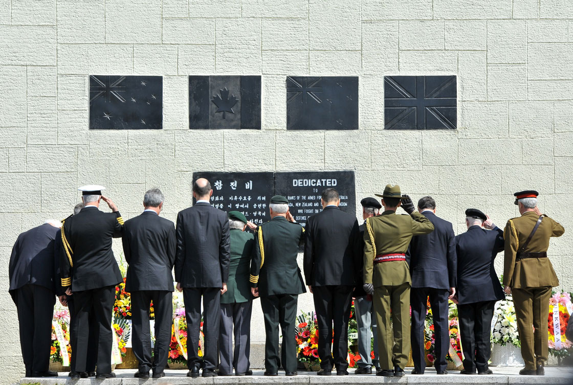 Military officers and veterans from British Commonwealth countries who fought alongside South Korea during the 1950-53 Korean War salute in front of a participation memorial in Gapyeong, 55 kilometers northeast of Seoul on April 24, 2013. 