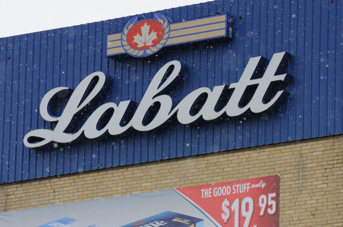 A close up of a building with a Labatt sign at the top.