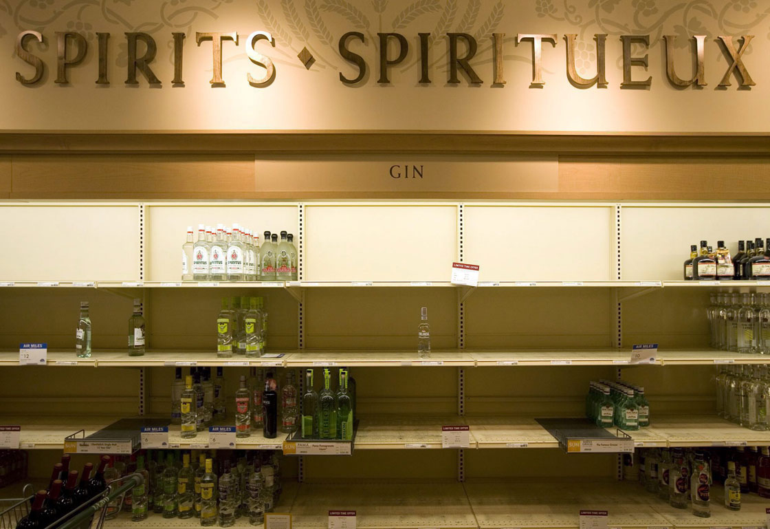 A few scattered bottles of liquor sit on virtually barren LCBO shelves in Toronto on Tuesday, June 23, 2009. 