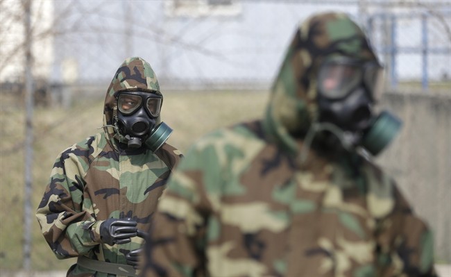 FILE: Soldiers wearing gas masks.