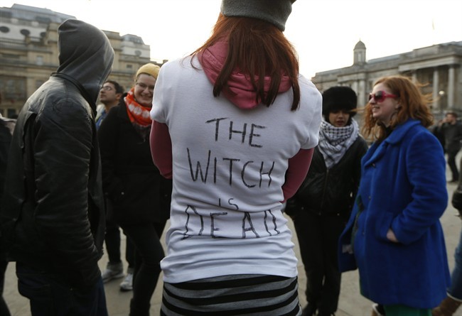 Anti-Thatcher protesters react to the death of former British Prime Minister as they gather at Trafalgar Square in London, Monday, April 8, 2013. Thatcher's spokesman, Tim Bell, said the former prime minister died from a stroke Monday morning at the Ritz hotel in London. Flags were flown at half-staff at Buckingham Palace, Parliament and Downing Street for the 87 year old. Queen Elizabeth II authorized a ceremonial funeral, a step short of a state funeral to be held for Thatcher at St. Paul's Cathedral in London next week with military honors. 'The Witch is Dead' on T-shirt refers to an Anti-Thatcher song. 