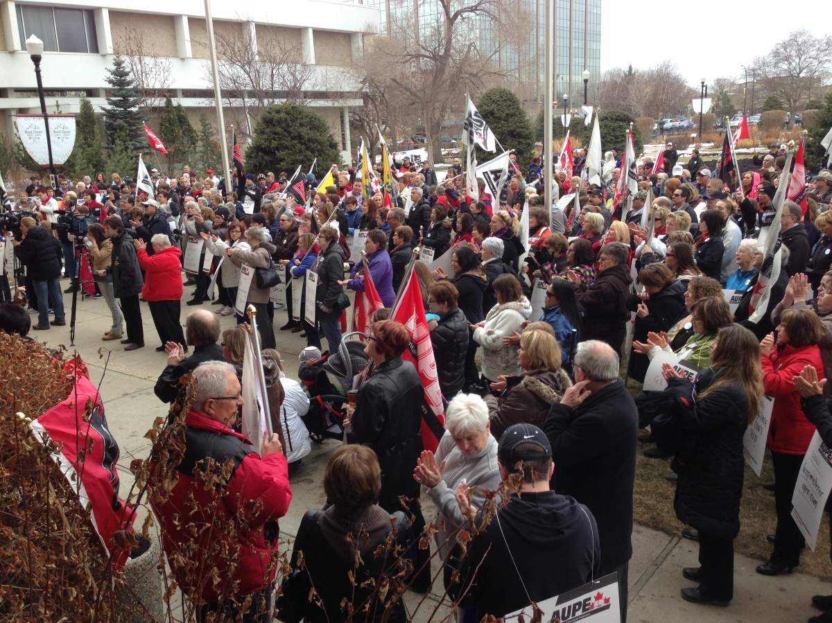 Dozens of people gather outside Red Deer's city hall  to protest plans to shut down the care facility.