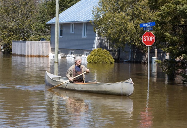 Minden, Ont. resident Doug Ripley takes to his canoe as the rising waters from the nearby Gull River surround his home on Monday, April 22, 2013. 