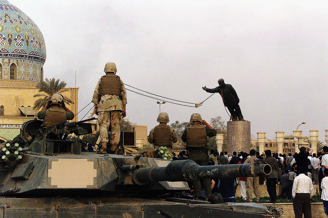 BAGHDAD, IRAQ - APRIL 9: (FILE PHOTO) U.S marines and Iraqis are seen on April 9, 2003 as the statue of Iraqi dictator Saddam Hussein is toppled at al-Fardous square in Baghdad, Iraq. 
