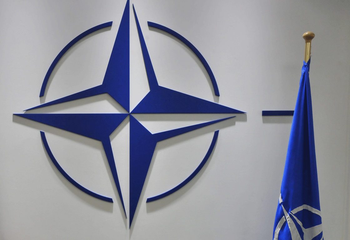 A NATO logo and flag are pictured at NATO headquarters on September 3, 2012 at the NATO headquarters in Brussels.