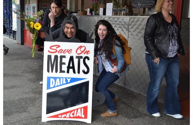 Save On Meats has created a new sandwich-board sign — complete with a face cut-out — to replace the one stolen last month by an anti-gentrification group. The new sign is designed to imitate a photo sent to owner Mark Brand, showing two individuals wearing black balaclavas posing with the snatched sign.