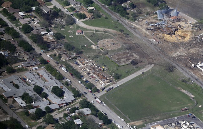 FILE - This Thursday, April 18, 2013 aerial photo shows the remains of a nursing home, left, apartment complex, center, and fertilizer plant, right, destroyed by an explosion in West, Texas. 