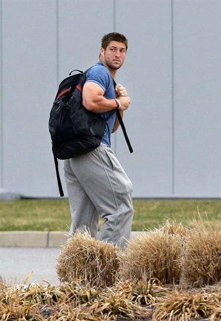 New York Jets quarterback Tim Tebow arrives on the first day of NFL football offseason workouts at the Jets practice facility in Florham Park, N.J. on April 15.