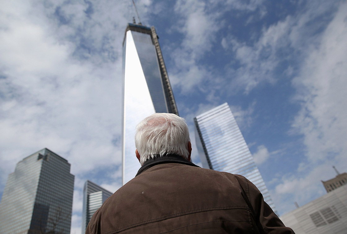 A visitor the the September 11 Memorial and Museum looks towards the One World Trade tower on April 16, 2013 in New York City