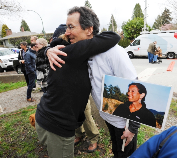 Peter Ladner gets a hug while he holds a picture of his sister prior to a press conference in Pacific Spirit Park in Vancouver, B.C. April 3, 2011. Ladner’s family will be attending an IHIT press conference on April 3 to mark the four-year anniversary of her murder.
