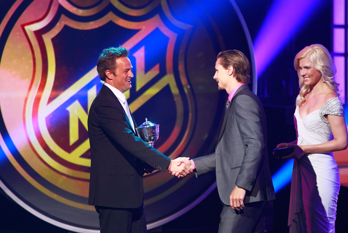 Actor Matthew Perry presents the Norris Trophy to Erik Karlsson of the Ottawa Senators during the 2012 NHL Awards.