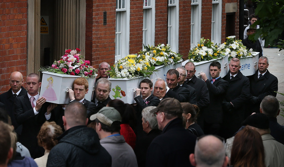 Pall bearers carry the coffins of the six Philpott children from St Mary's Church after a funeral service on June 22, 2012 in Derby, England. 