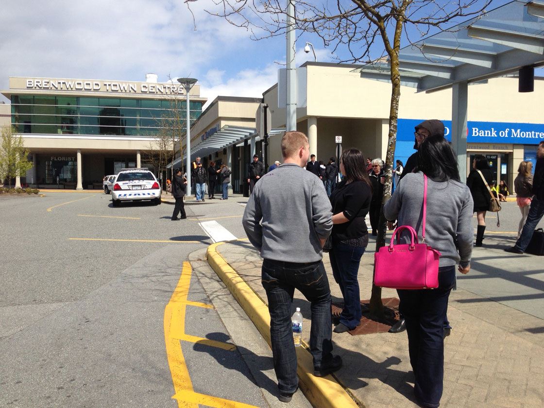 Shoppers stand outside Brentwood Mall.