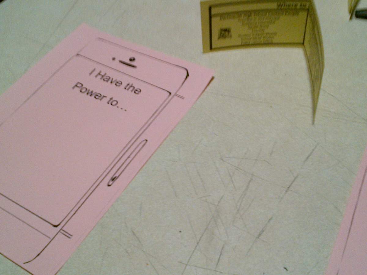Pledge forms and help information cover the table of the We Have the Power campaign at Dartmouth High School.