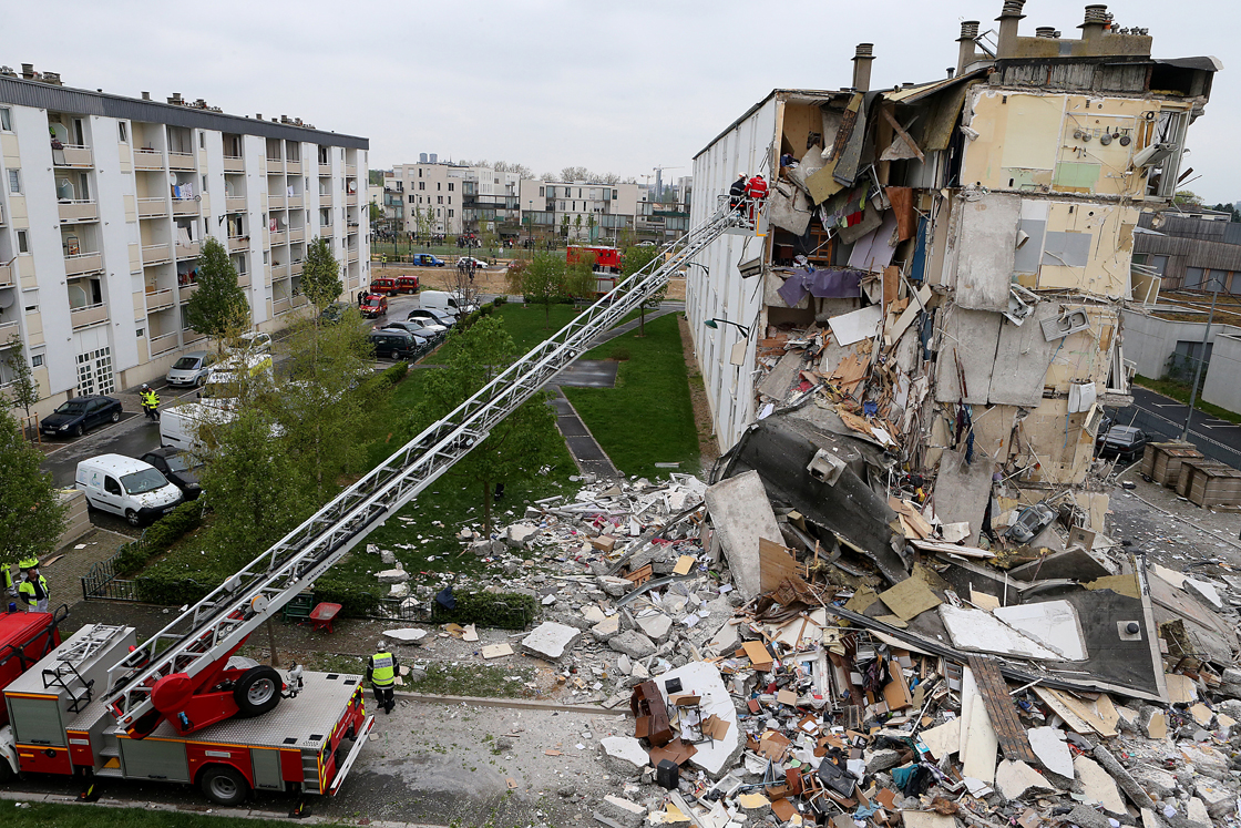 Firemen are at work near the collapsed section of an apartment building on April 28,  2013 in Reims, eastern France, after a suspected gas explosion killed at least two people and injured nine others leaving people trapped under debris, authorities said.
