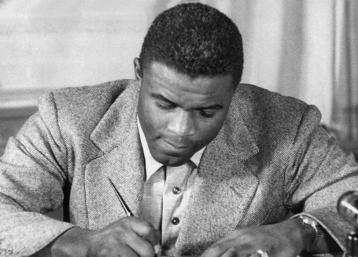 Jackie Robinson signs to Brooklyn Dodgers