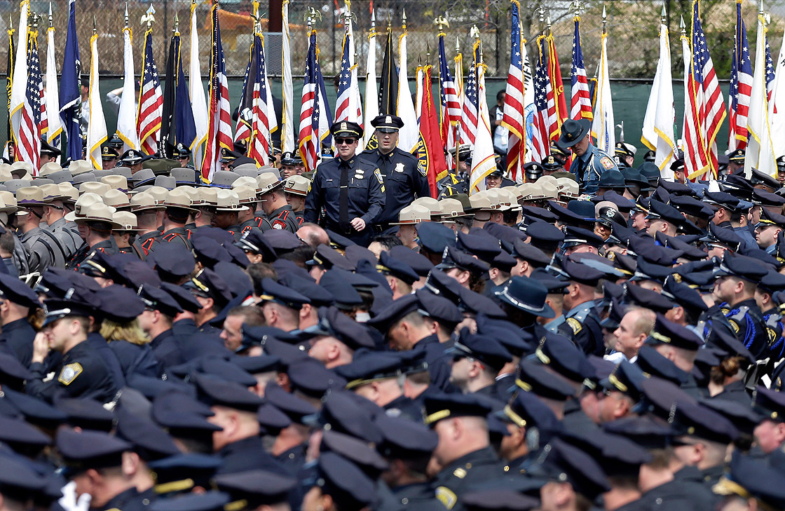 Police officers arrive to a memorial service for fallen Massachusetts Institute of Technology campus officer Sean Collier at MIT in Cambridge, Mass. Wednesday, April 24, 2013. Authorities say Collier was killed by the Boston Marathon bombing suspects last Thursday, April 18. He had worked for the department a little more than a year. 