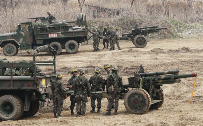 South Korean army soldiers conduct military exercise in Paju, South Korea, near the border village of Panmunjom, Tuesday, April 16, 2013. The north is demanding an end to joint U.S.-South Korean military exercises as one of their preconditions to negotiations aimed at preventing war on the Korea peninsula.  