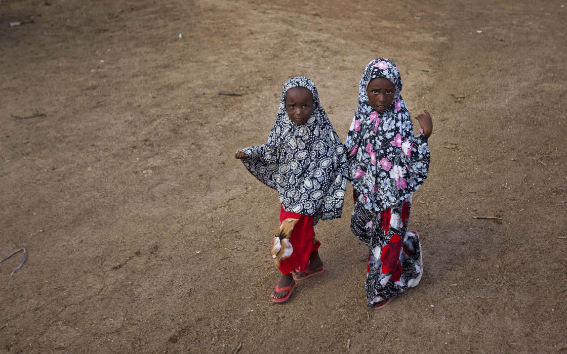 Two young Somali girls walk hand-in-hand in Tabda, Somalia.