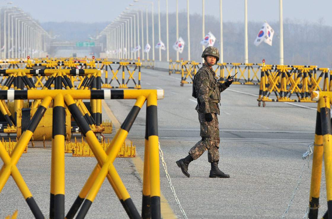 A South Korean soldier walks beside barricades on a road leading to North Korea's Kaesong joint industrial complex, at a military checkpoint in the border city of Paju on April 8, 2013.  