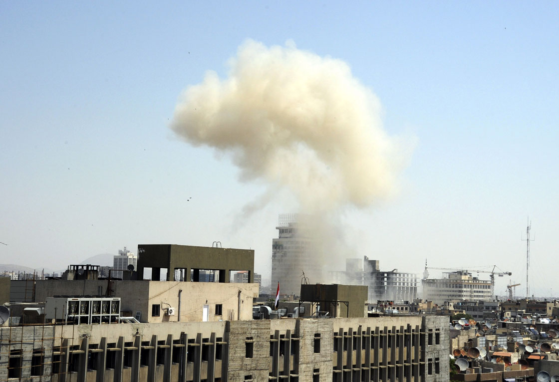This photo released by the Syrian official news agency SANA, shows billowing smoke from a powerful explosion that shook Damascus in the central Marjeh district of Damascus, Syria, Tuesday, April. 30, 2013. 