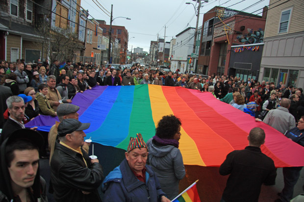Hundreds of people crowded onto the block of Gottingen St., where 49-year-old Raymond Taavel was murdered early Tuesday.