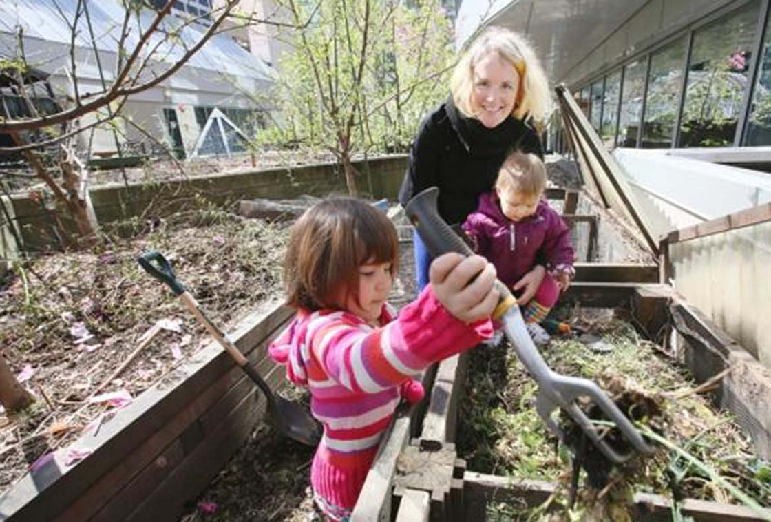 Urban Farm School founder and instructor Tara Moreau, shown with gardening children Betsy, left, and Etta, will hold 25 classes on the rooftop of the downtown YWCA for hands-on instruction on soil management and maximizing yields in small spaces.
